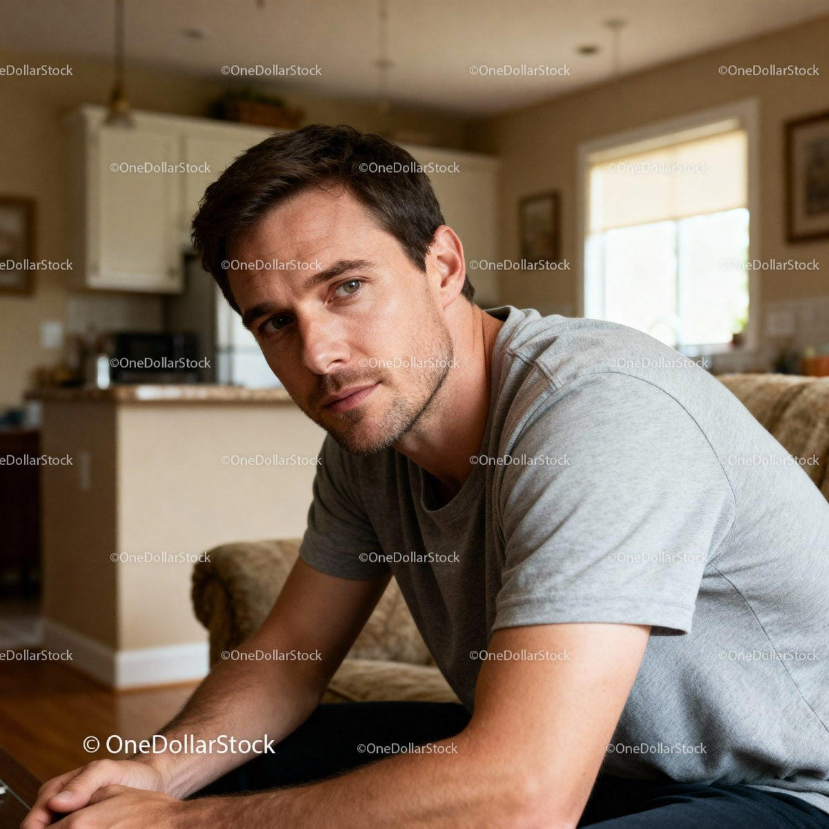 Thoughtful young man sitting relaxed at home