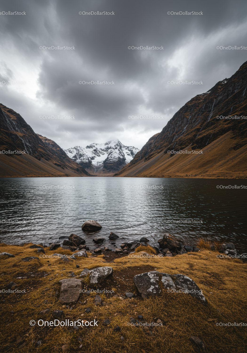 Majestic Mountain Lake with Snow-Capped Peaks and Dramatic Clouds