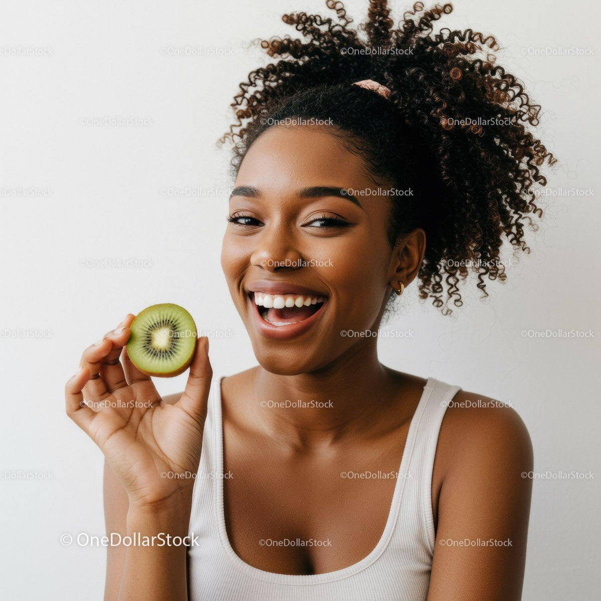 Vibrant Young Woman with Curly Hair Enjoying Fresh Kiwi Fruit