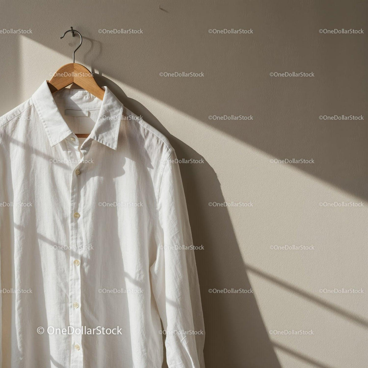 White Cotton Shirt Hanging on Wooden Hanger in Soft Light JPG Mockup Image preview