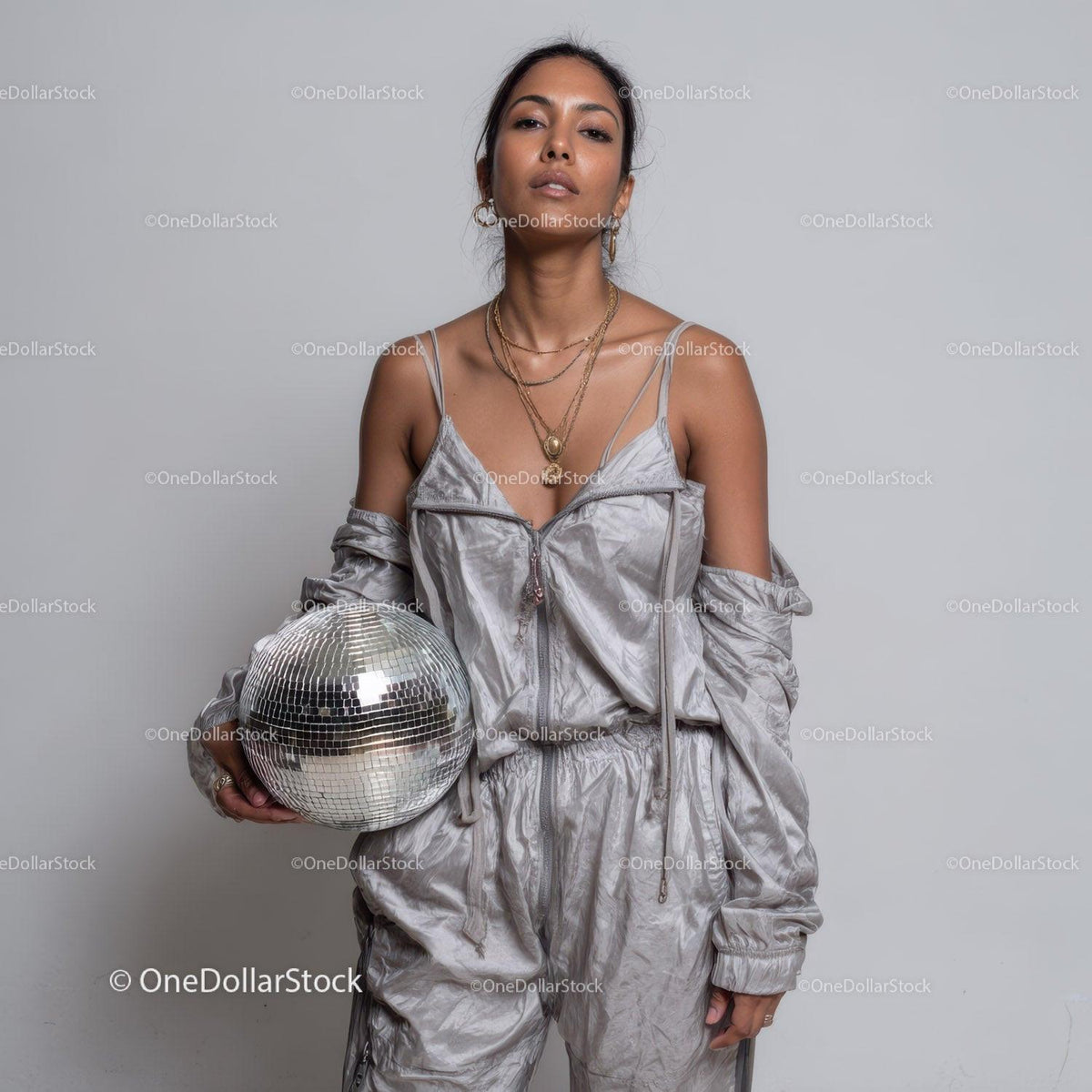 Stylish Woman in Metallic Outfit Holding Disco Ball for Modern Fashion Stock Photo Bundle preview 10