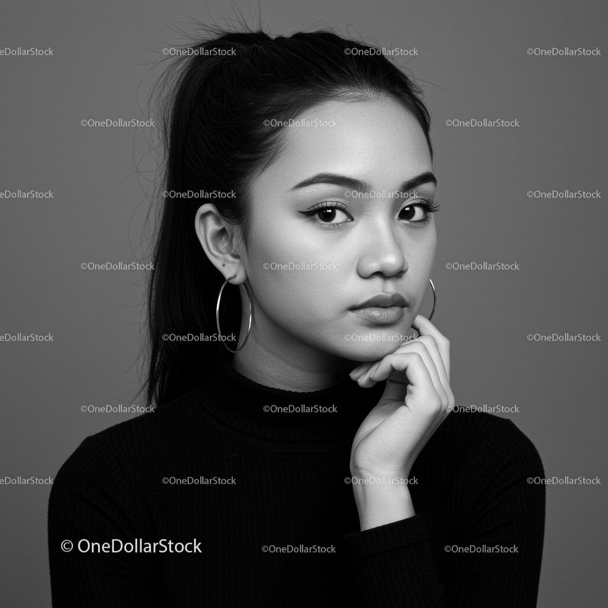 Elegant Black and White Portrait of Young Woman with Hoop Earrings