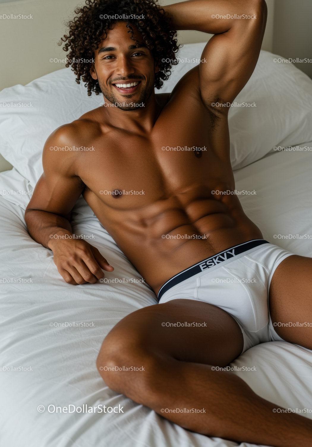 Smiling man relaxing on bed in white underwear