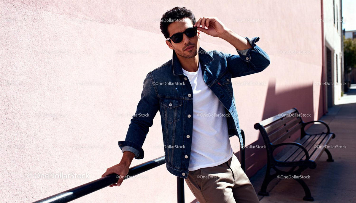 Stylish young man leaning on railing outdoors