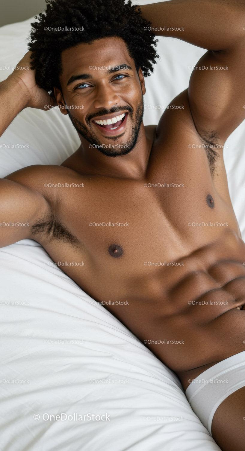 Smiling man with blue eyes relaxing on white bed
