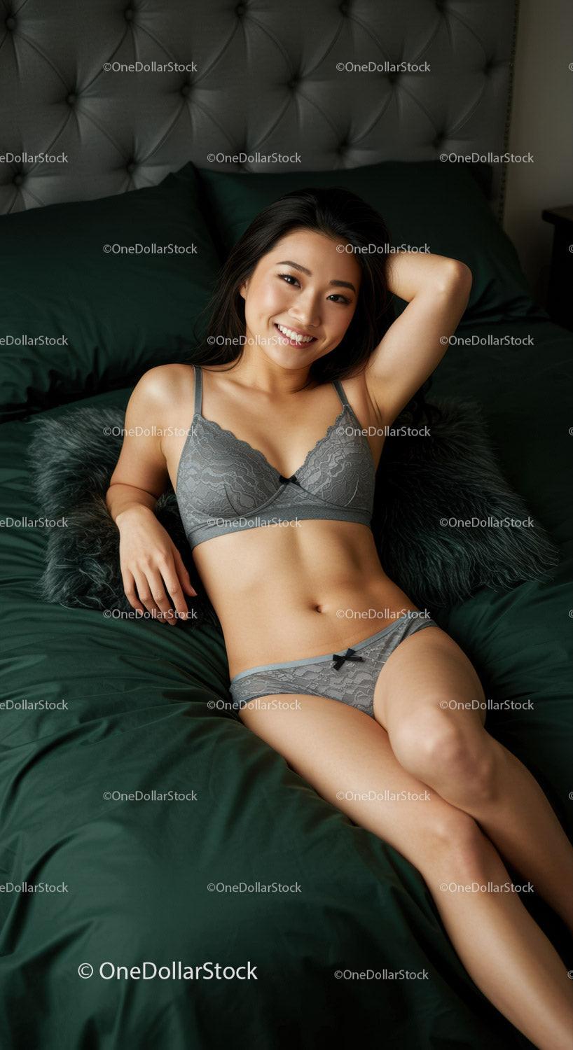 Smiling woman relaxing on dark green bed in lace lingerie