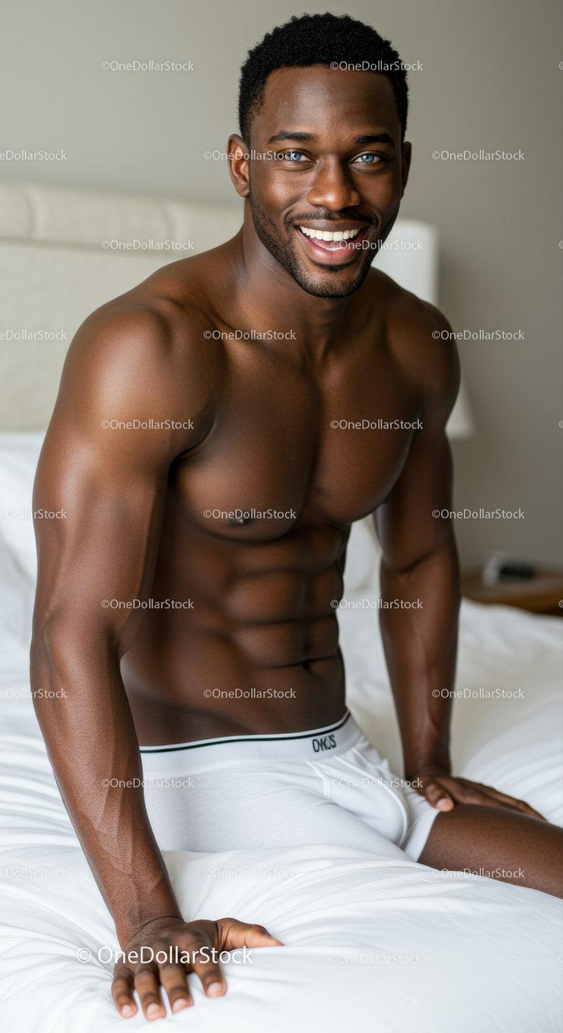 Fit man with bright smile relaxing on bed in underwear