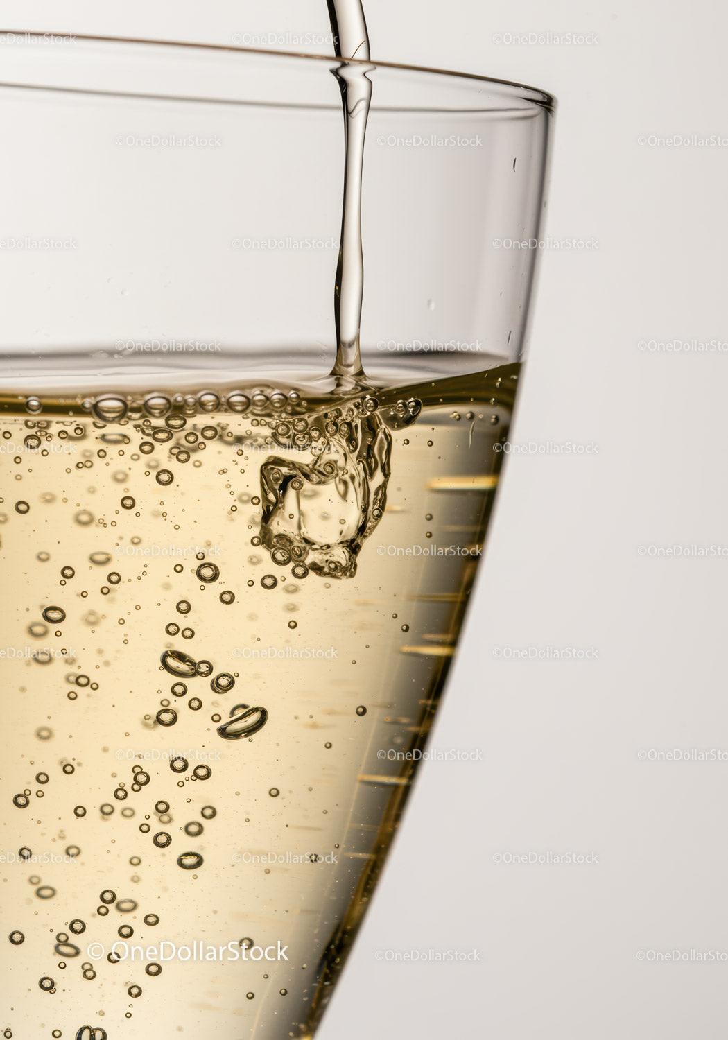 Golden sparkling wine pouring into glass with bubbles