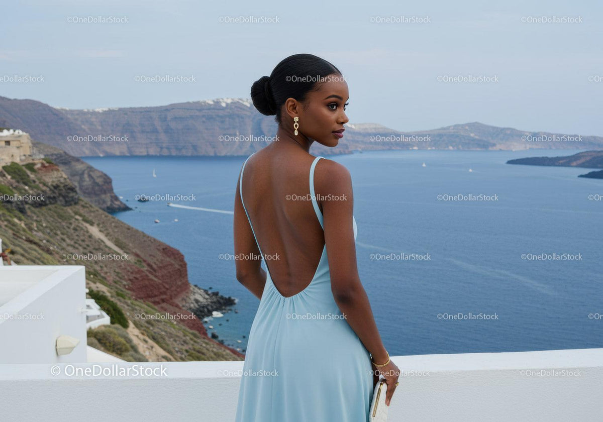 Elegant woman in light blue dress near sea cliff view