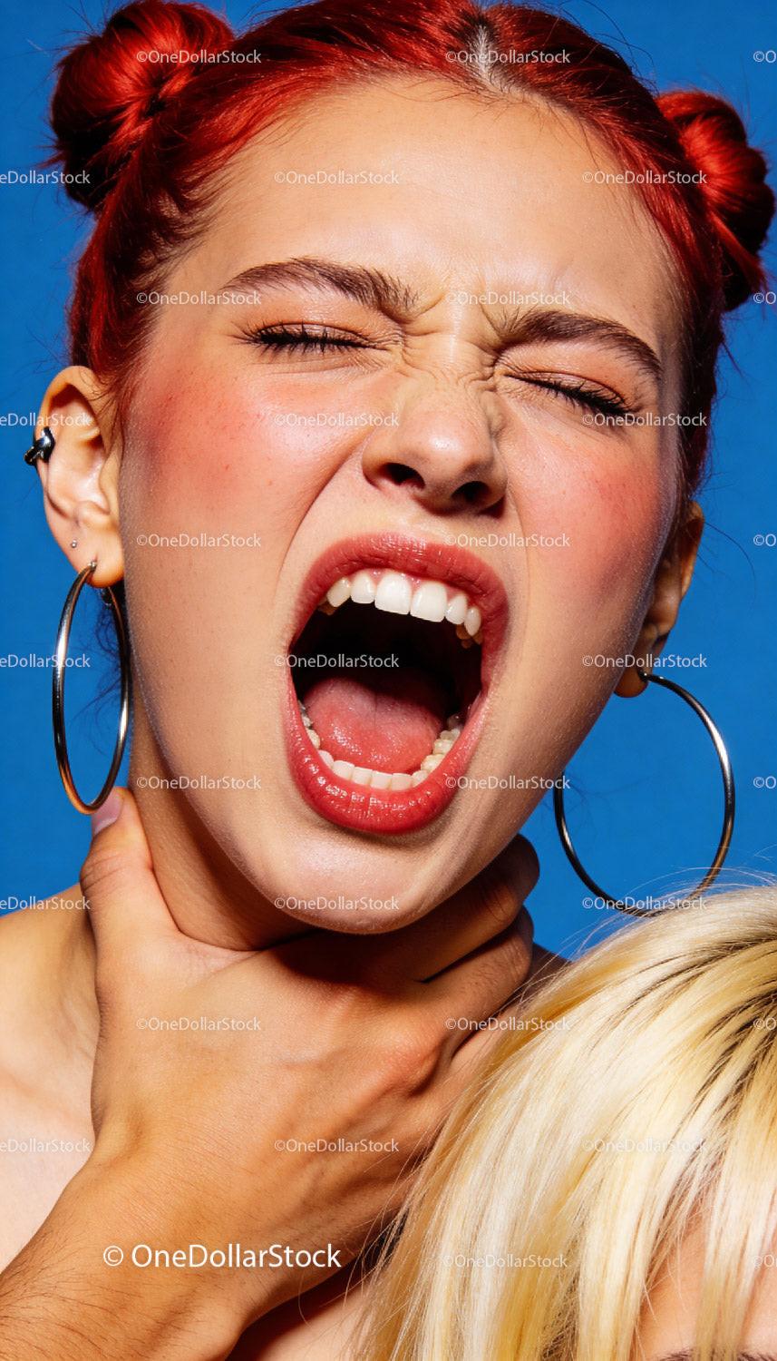 Frustrated young woman with red hair shouting intensely