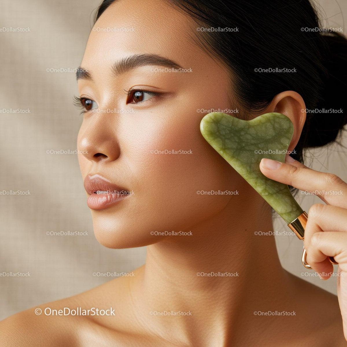 Close-Up of Woman Using Jade Gua Sha for Facial Massage and Skin Rejuvenation