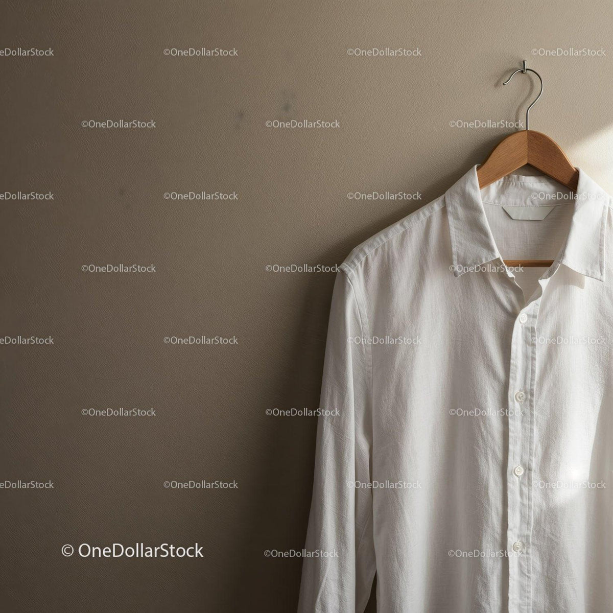 Crisp white shirt hanging on wooden hanger indoors JPG Mockup Image preview