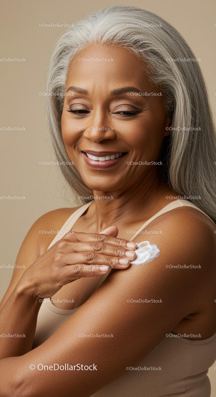 Elderly Woman Applying Lotion with a Joyful Smile for Skincare