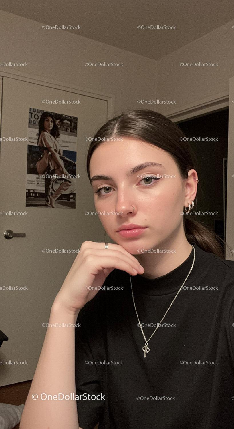 Young woman with nose piercings and jewelry in indoor setting