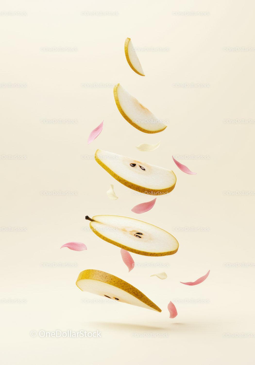 Floating pear slices with delicate pink petals