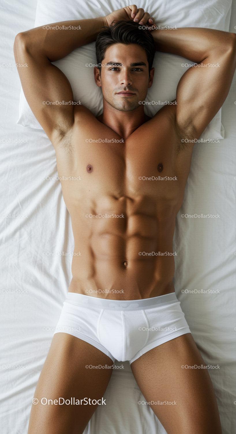 Fit young man relaxing on bed wearing white underwear