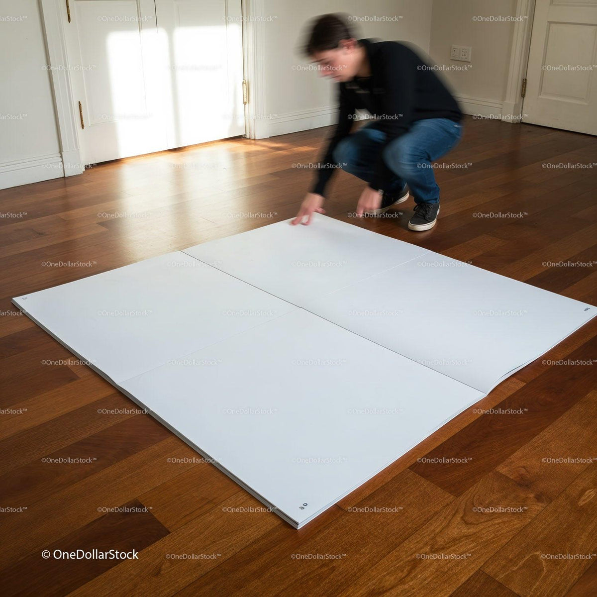 Man arranging large white panels on wooden floor indoors JPG Mockup Image preview