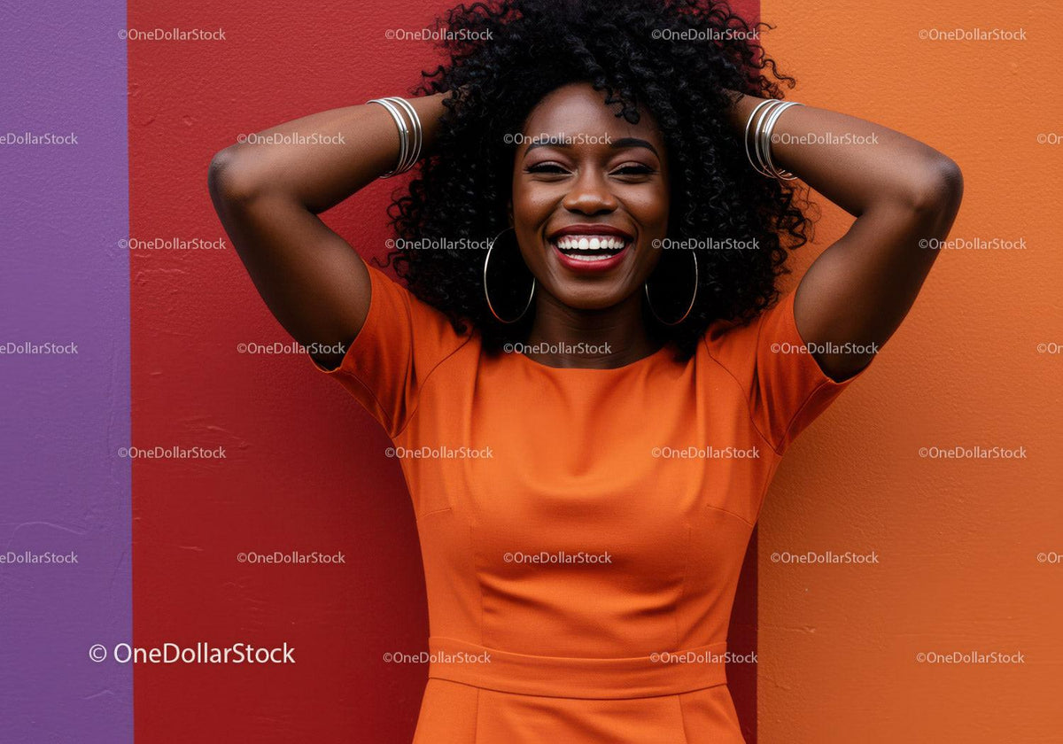 Joyful Woman in Bright Orange Dress with Curly Hair Against Colorful Wall