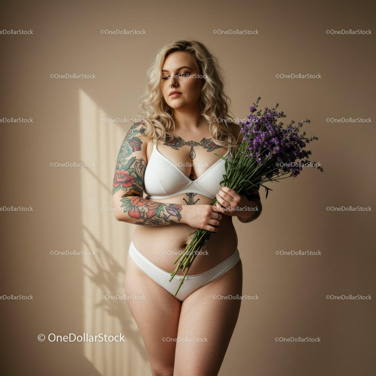 Tattooed Woman Holding Lavender Bouquet in Modern Indoor Portrait