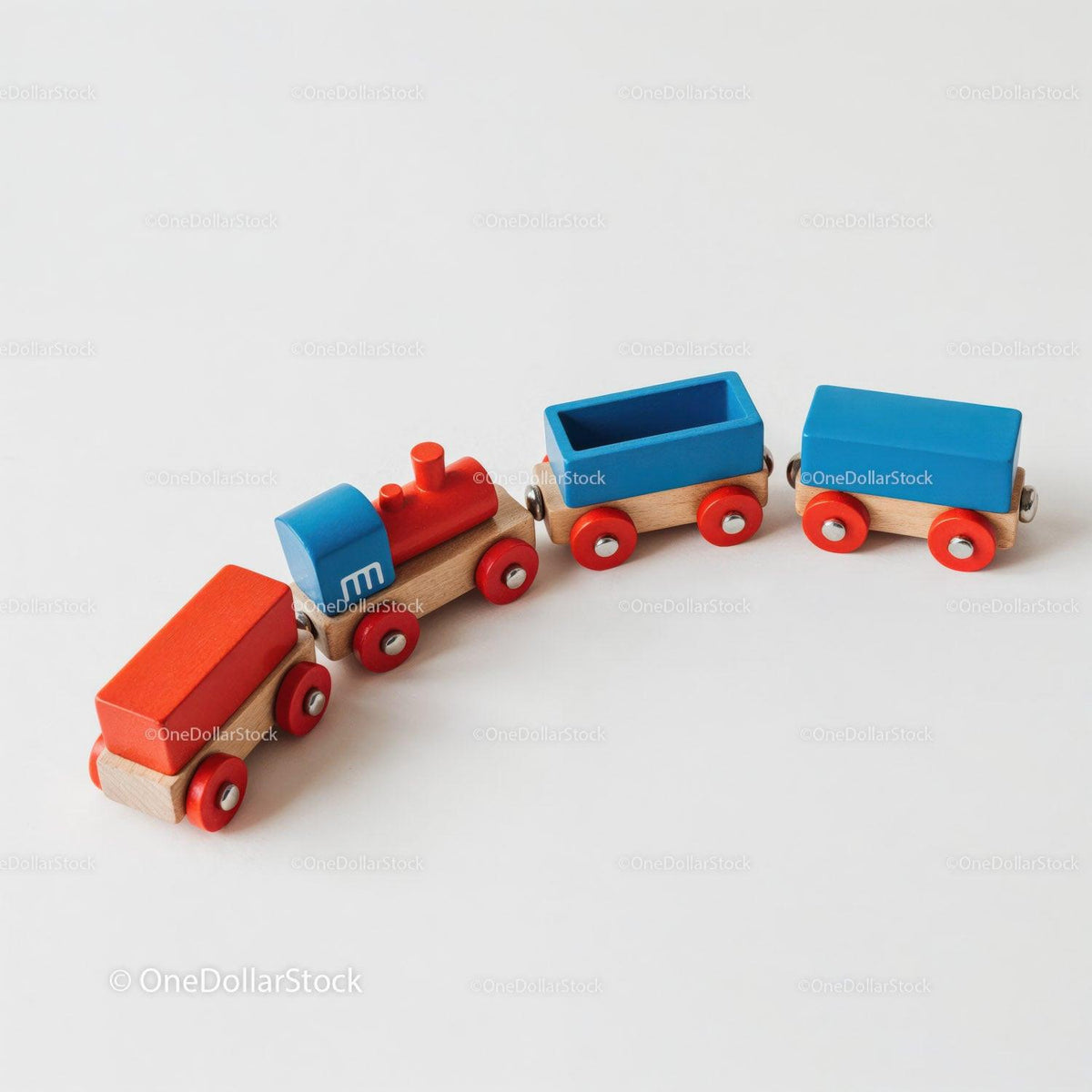 Wooden toy train set with blue and red cars and red wheels on white surface