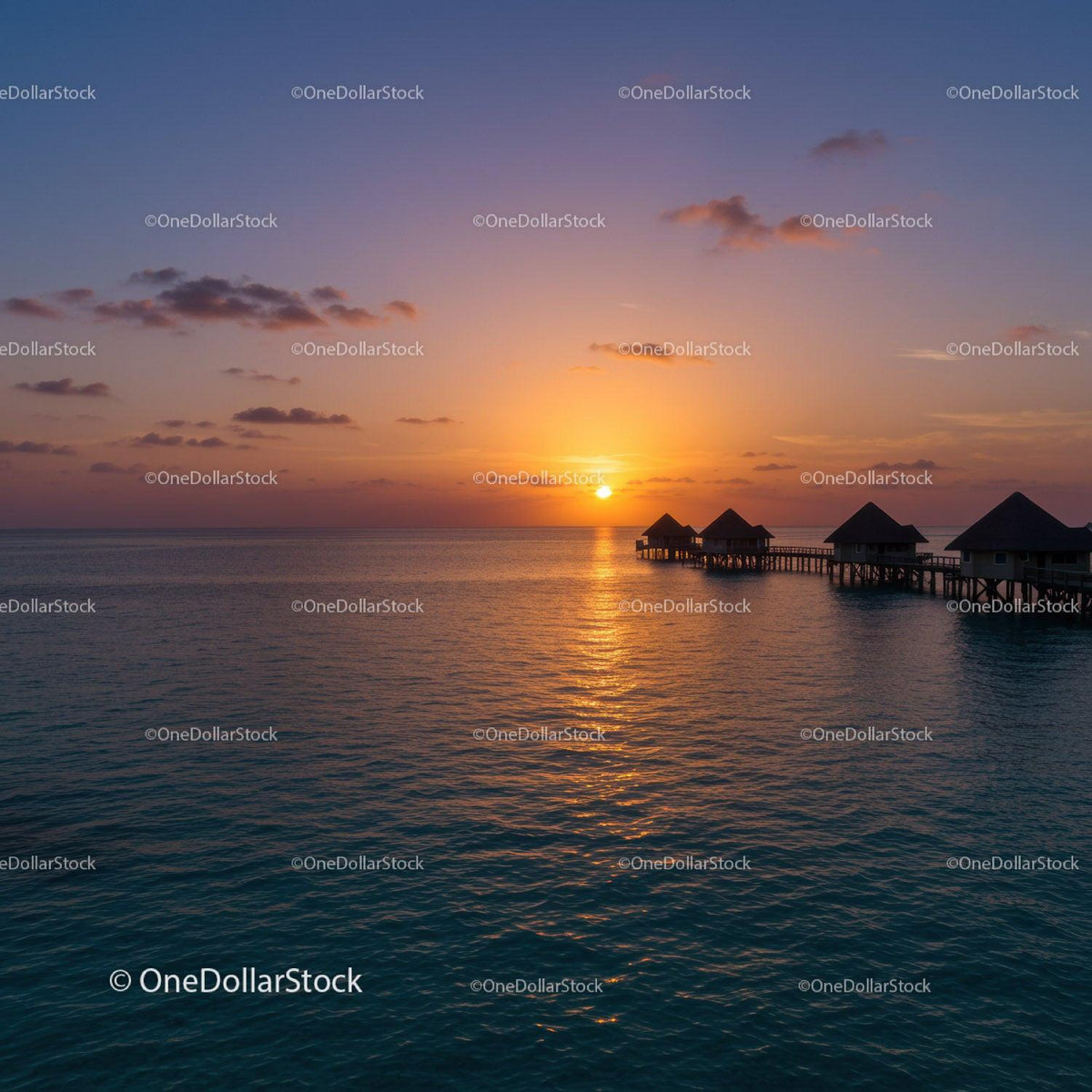 Beautiful Sunset Over Water Bungalows with Calm Ocean View
