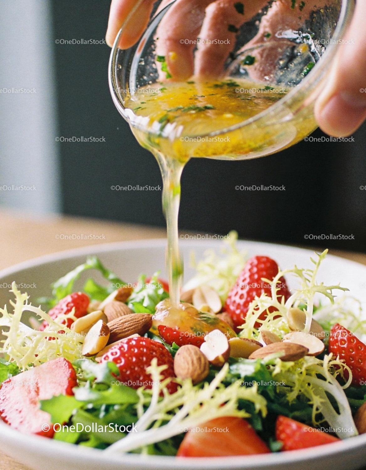 Fresh strawberry salad with nuts and citrus dressing