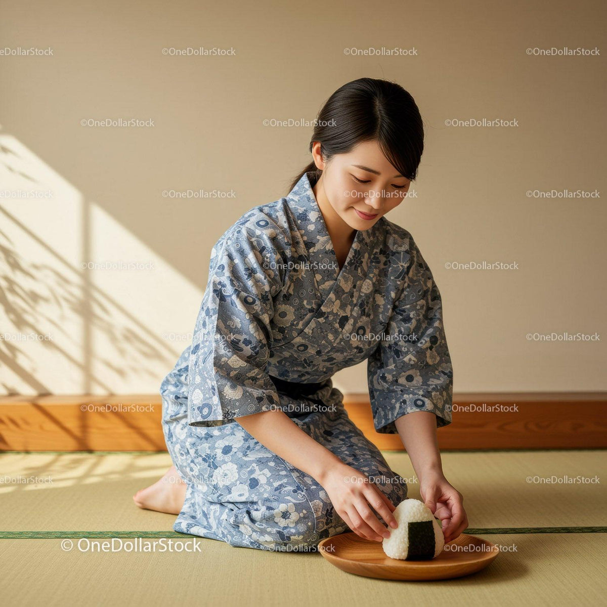 Woman in Traditional Yukata Serving Japanese Rice Ball