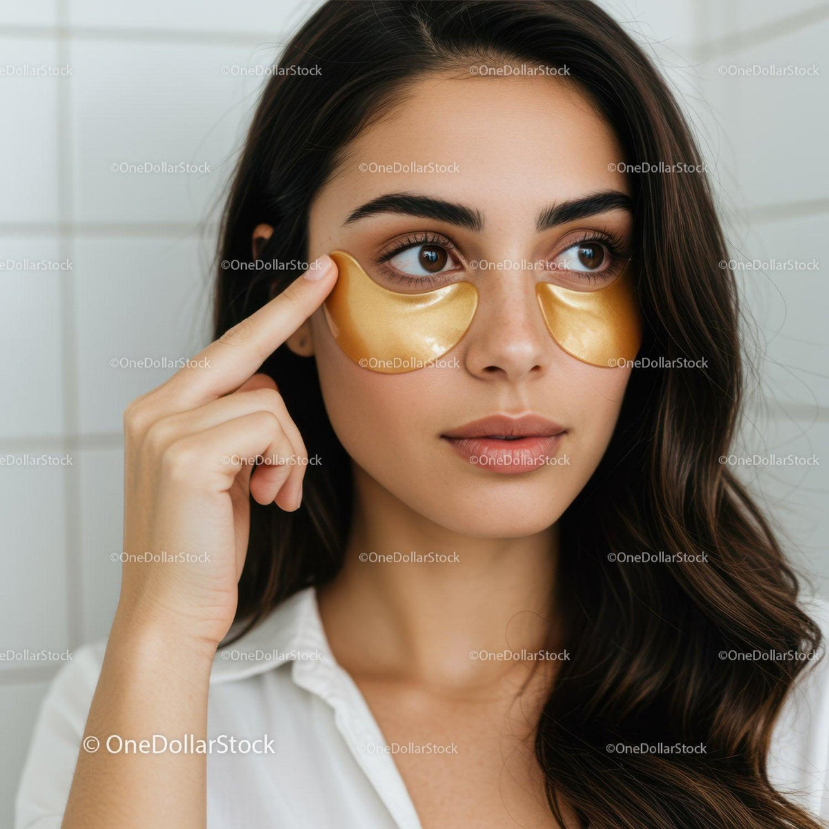 Young Woman Applying Gold Under-Eye Collagen Patches for Skin Rejuvenation