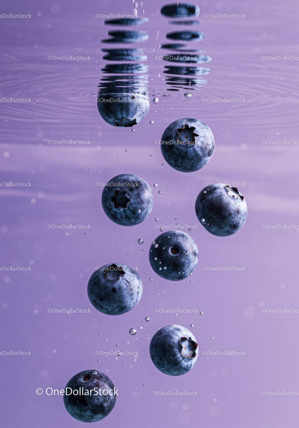 Fresh blueberries suspended in clear water with bubbles