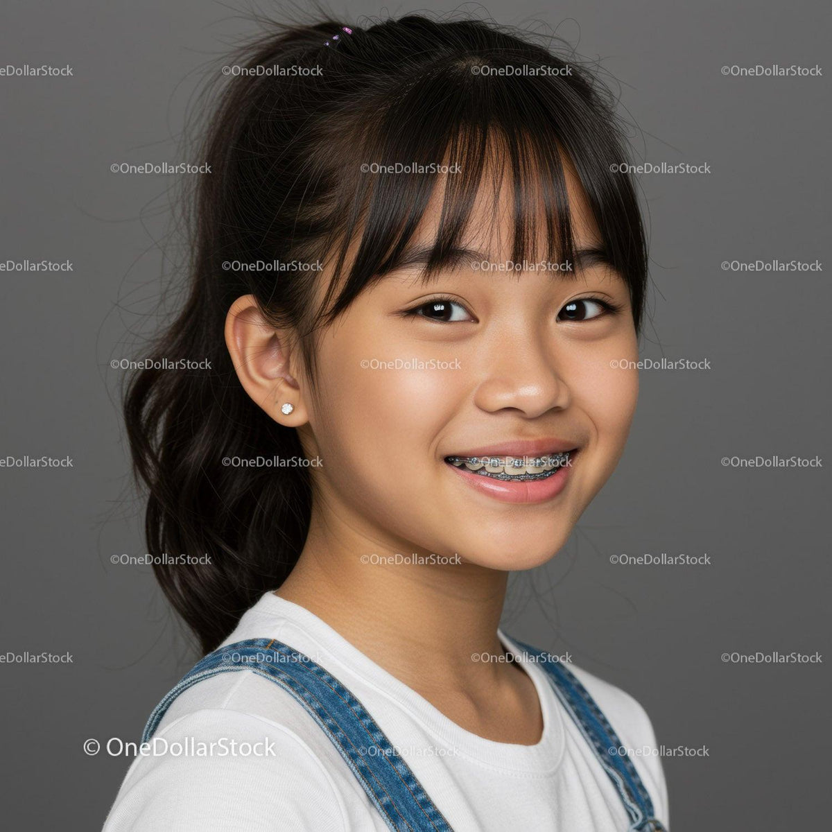 Smiling Asian Girl with Braces Wearing Denim Overalls and White T-Shirt