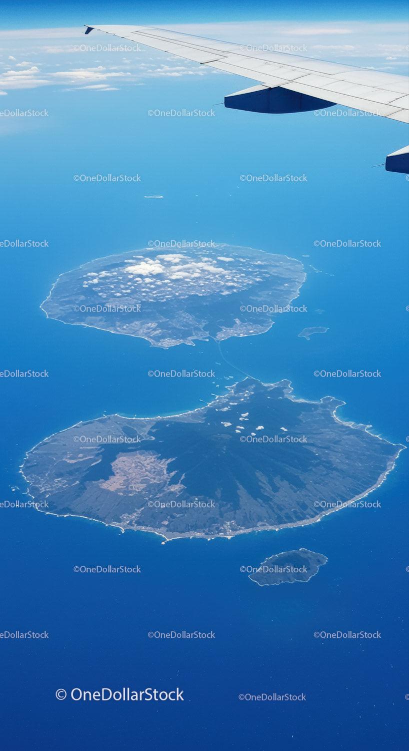 Aerial View of Volcanoes and Islands Below from an Airplane Window