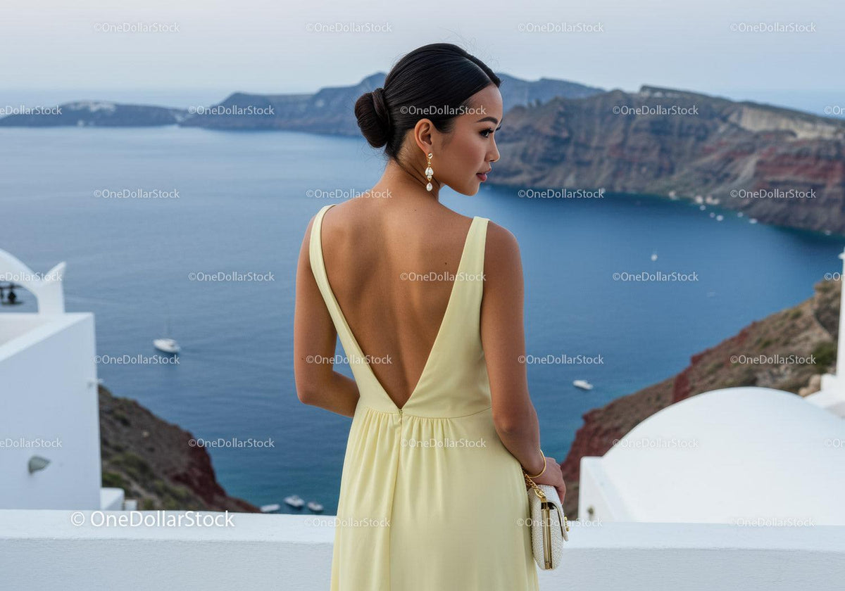 Woman in elegant dress overlooking serene ocean view