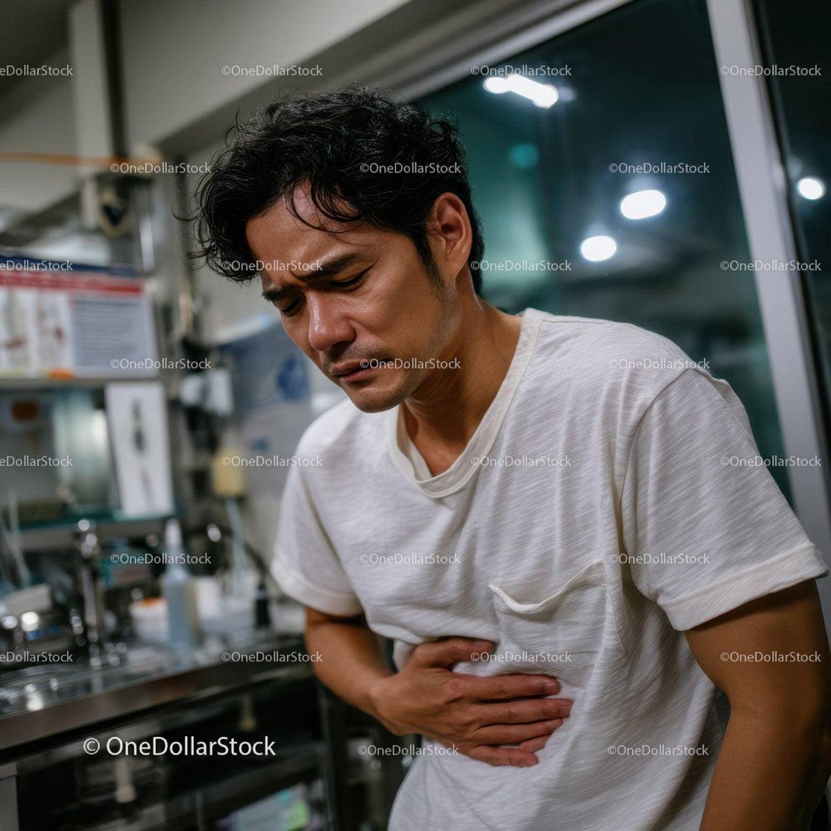 Man Suffering from Abdominal Pain in Indoor Setting