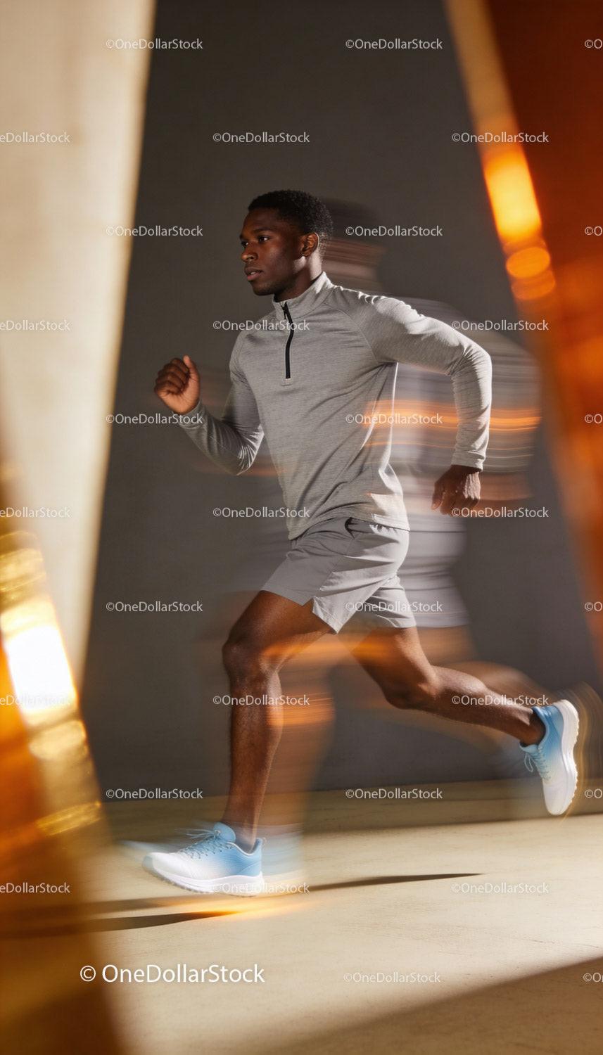 Focused Man Running Indoor in Athletic Gear