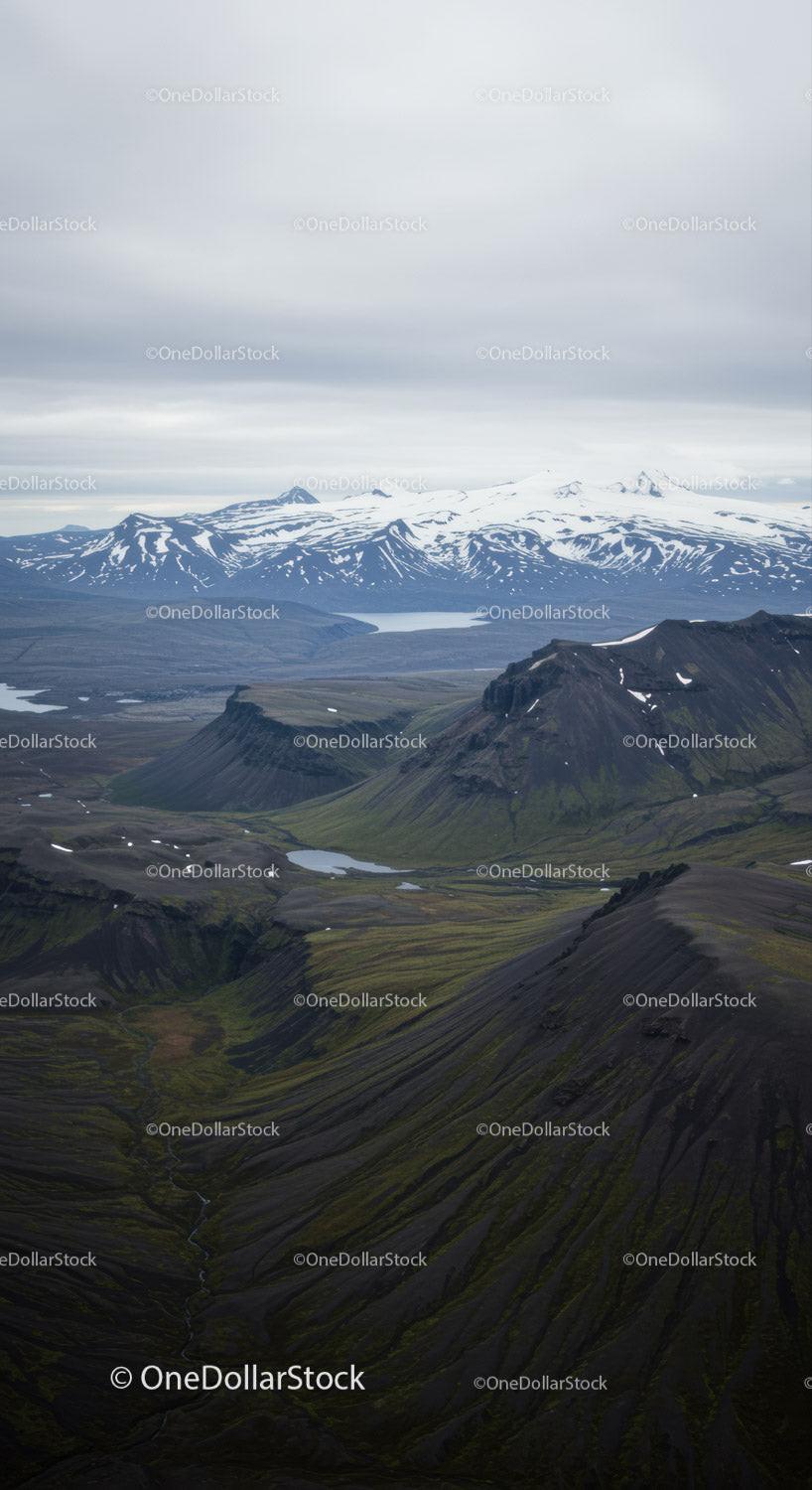 Scenic Mountain Landscape with Snow-Capped Peaks and Mossy Hills