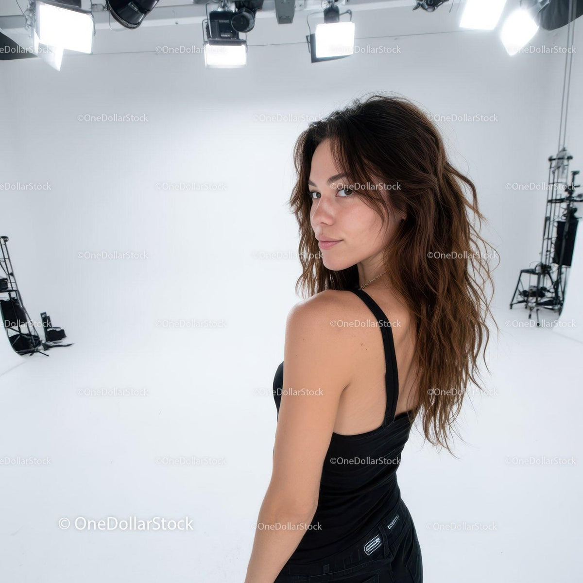 Confident Woman with Wavy Hair and Black Tank Top in Studio Setting
