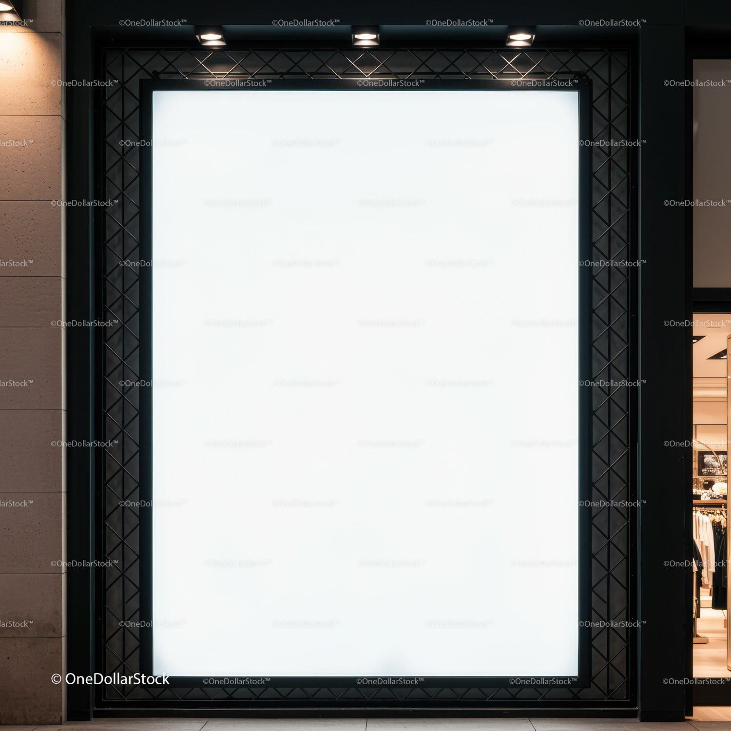 Blank illuminated storefront advertising display at night