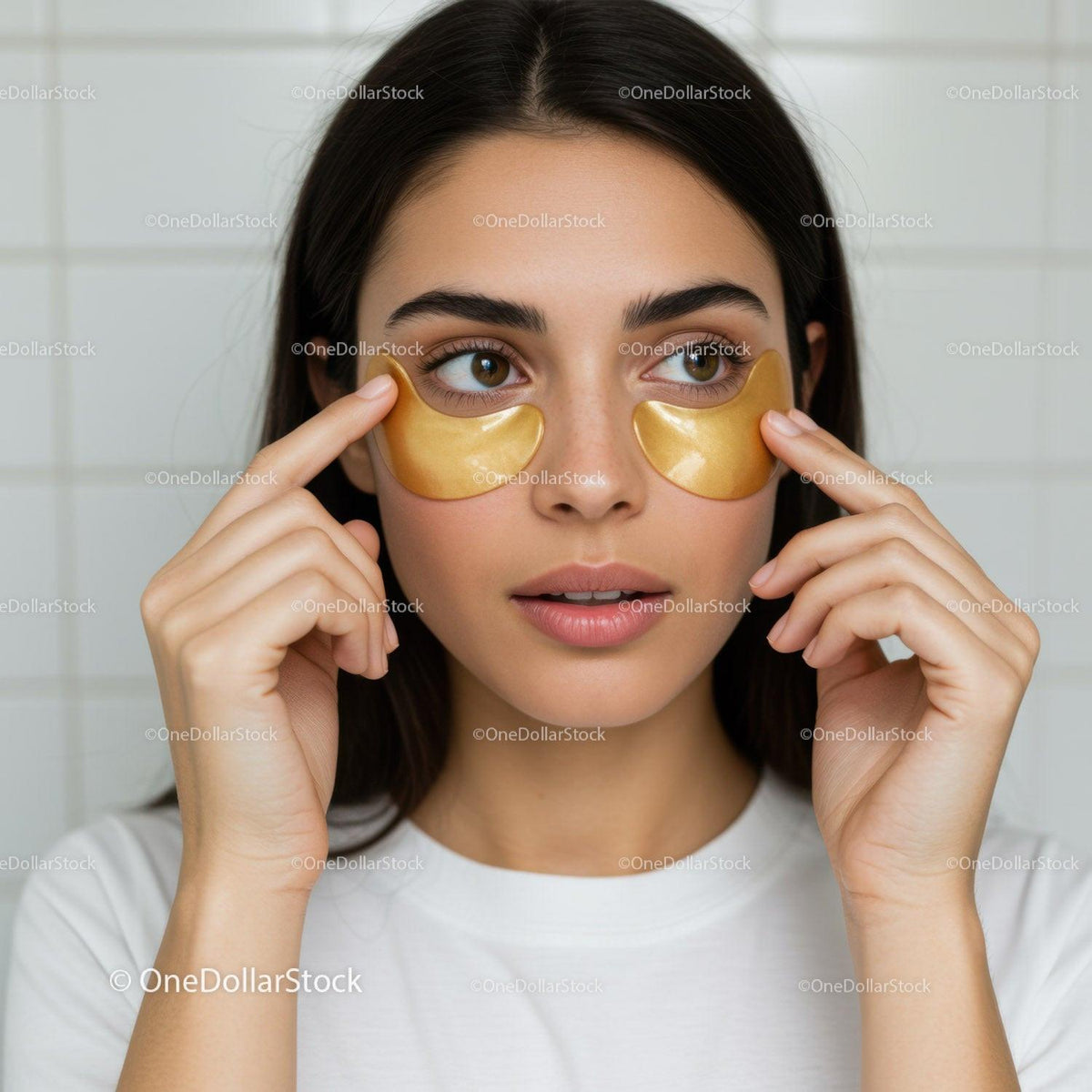Young Woman Applying Gold Eye Patches for Beauty and Skincare