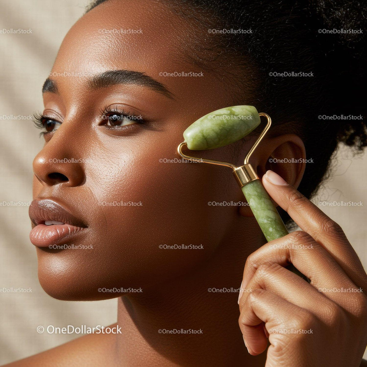 Elegant Woman Using Jade Roller for Facial Massage with Calm Expression