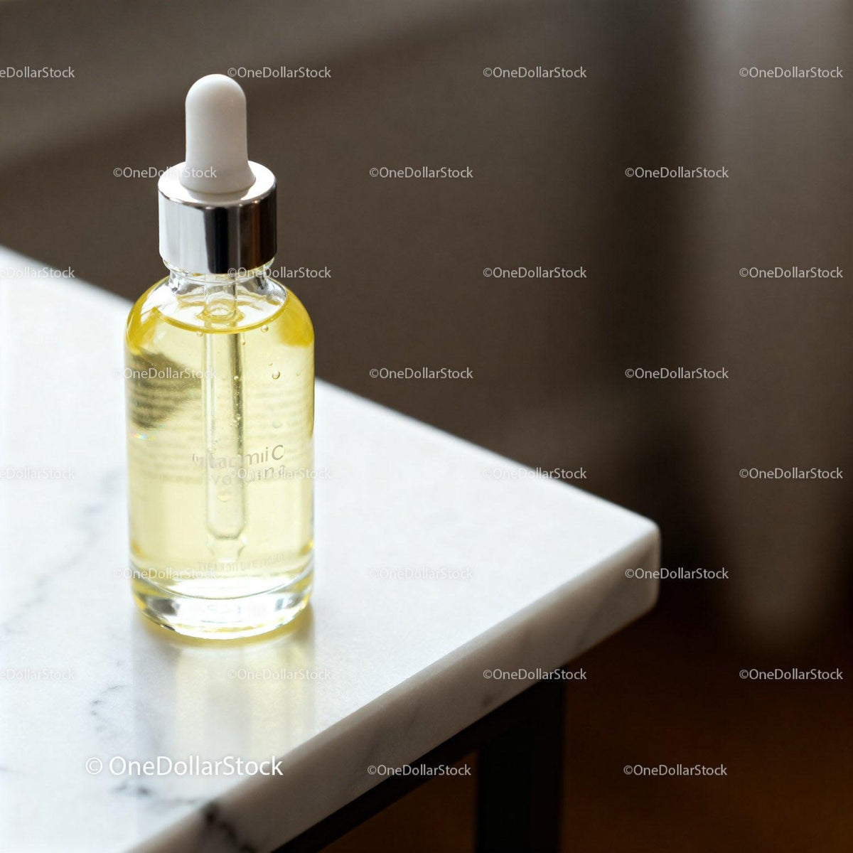 Glass Dropper Bottle with Vitamin C Serum on Marble Table