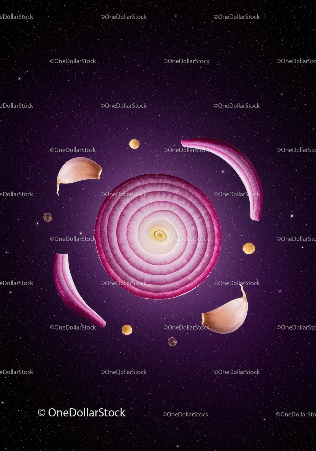 Sliced red onion and garlic arranged like a galaxy