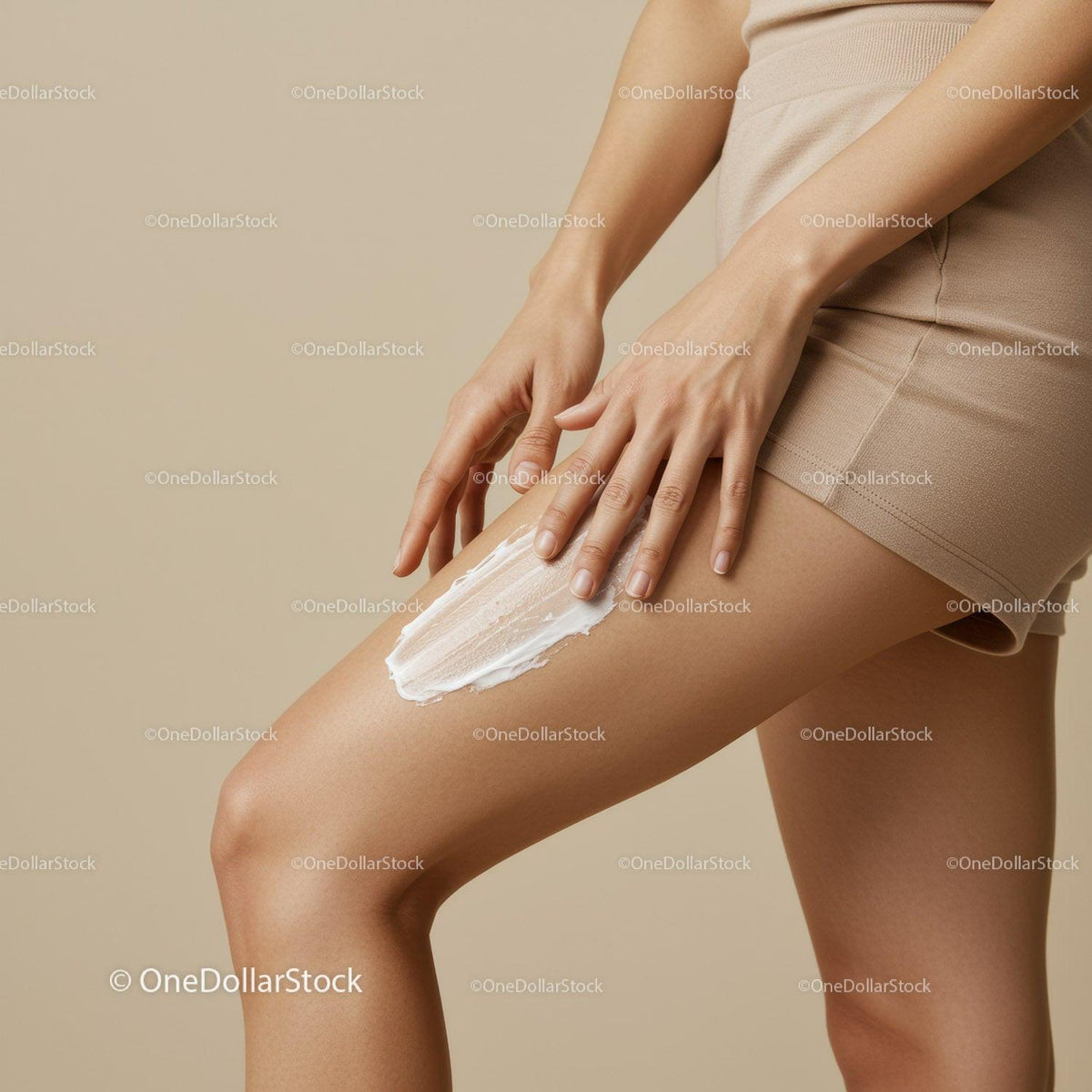 Close-up of Woman Applying Body Lotion on Thigh for Smooth Skin
