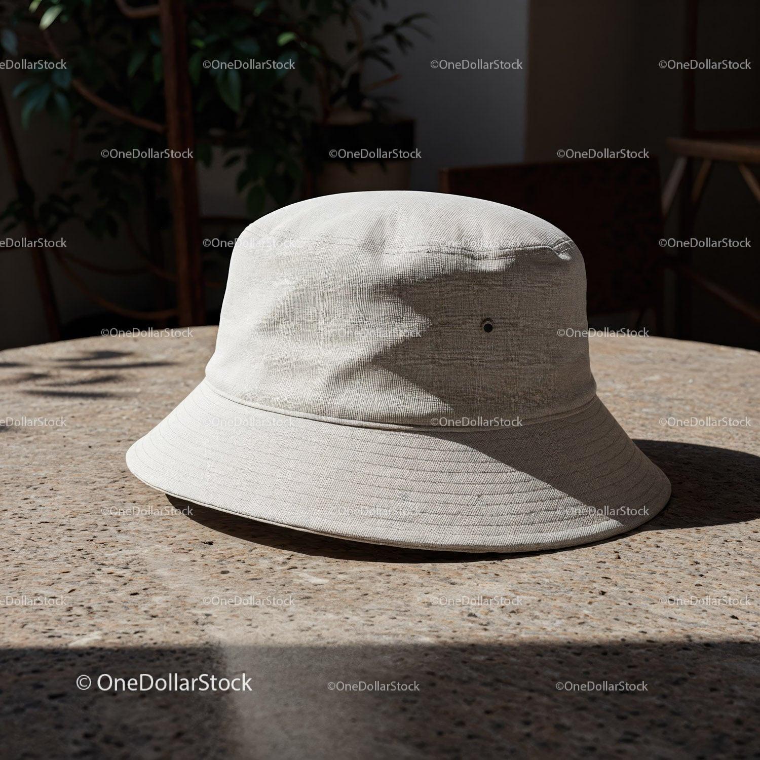 Minimalist beige bucket hat on textured table outdoors