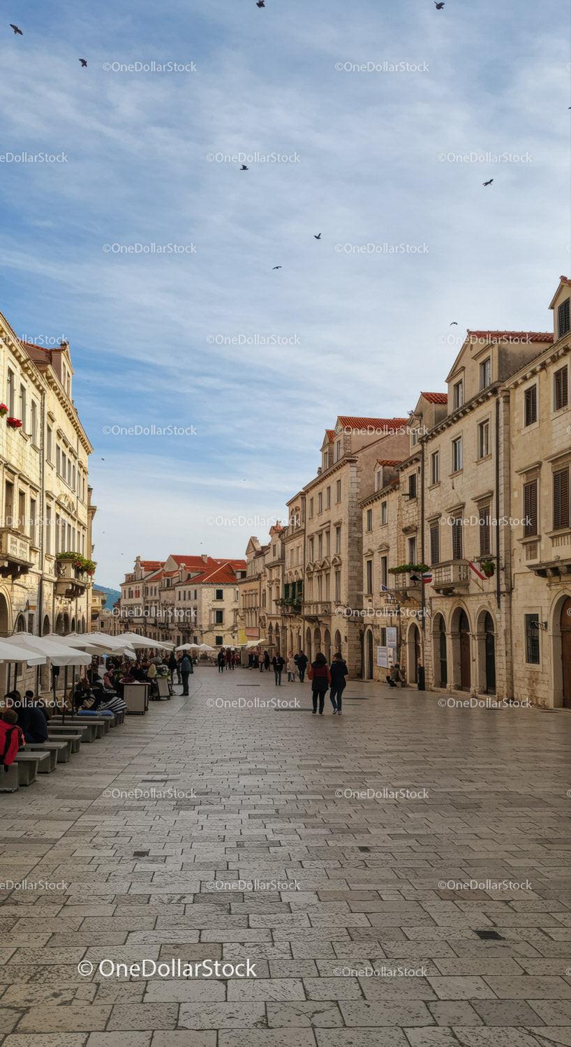 Charming European City Street with Historic Architecture and Outdoor Cafes