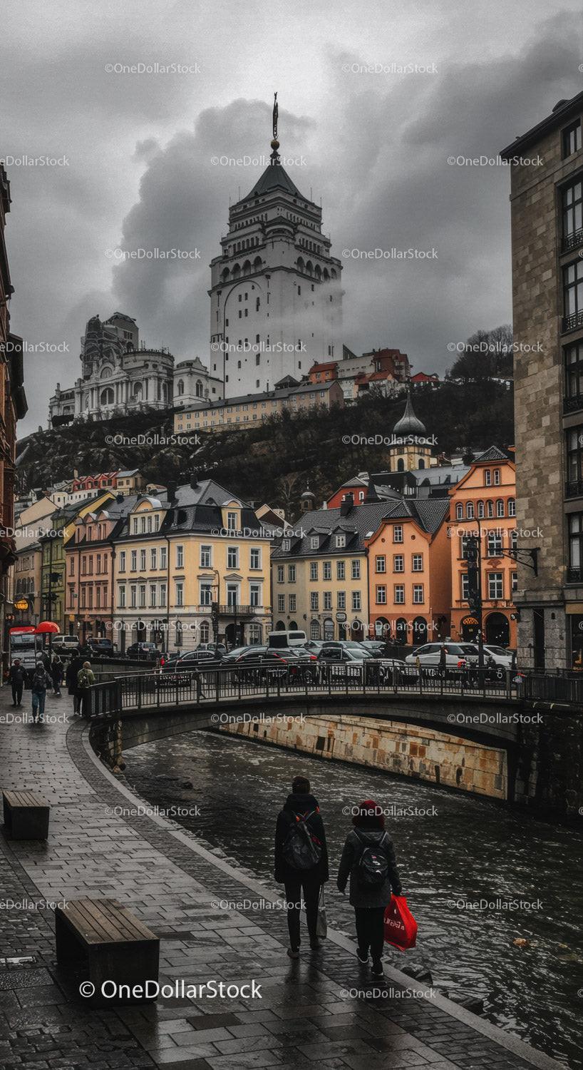 Gothic Castle Tower Over Historic Cityscape with Colorful Houses