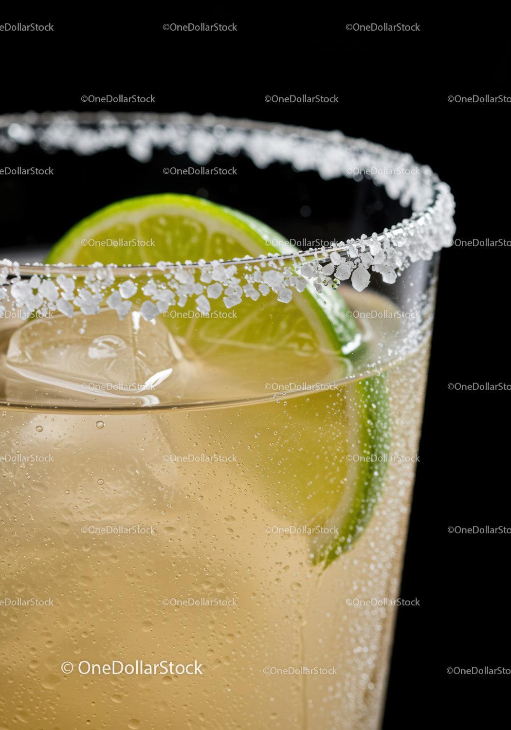 Refreshing cocktail with salted rim and lime wedge