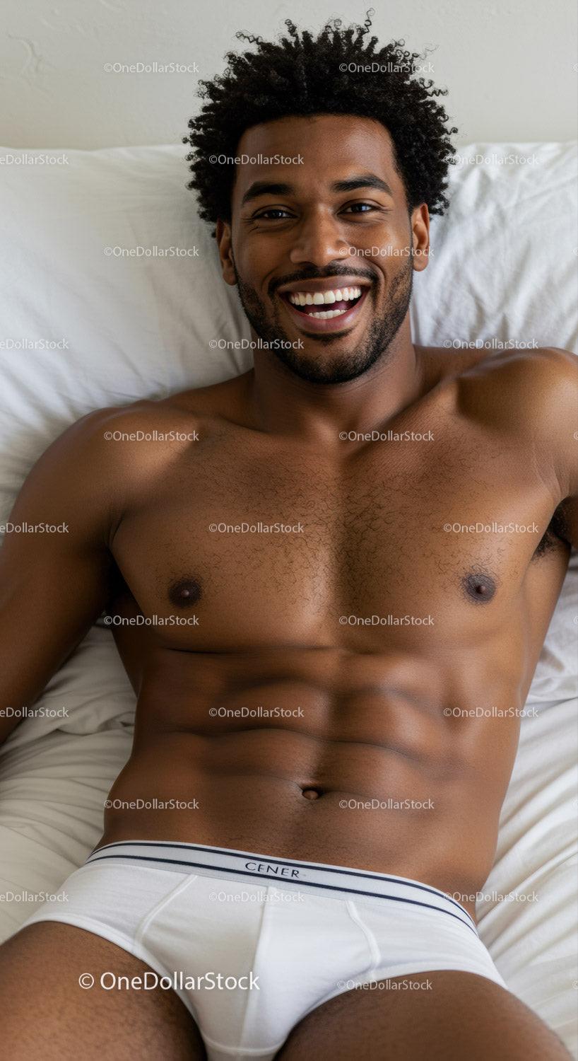 Smiling muscular man relaxing on bed in white underwear