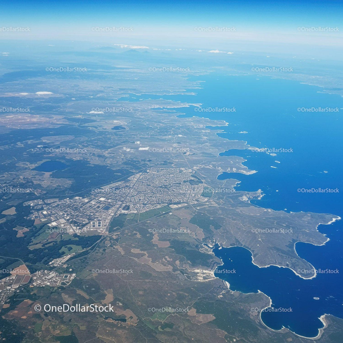 Scenic Aerial View of Coastal City with Lakes and Green Spaces