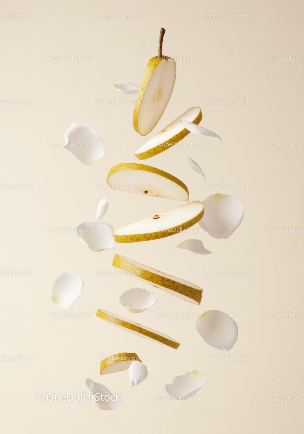 Floating Sliced Pear with Delicate White Flower Petals