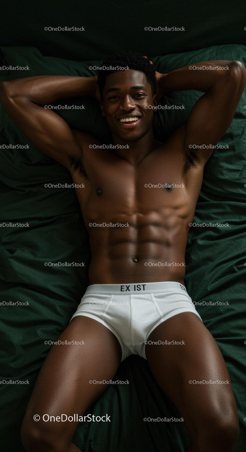 Relaxed young man lying on bed with confident smile